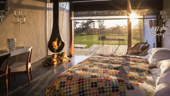 Bedroom with hanging fireplace at Areias do Seixo