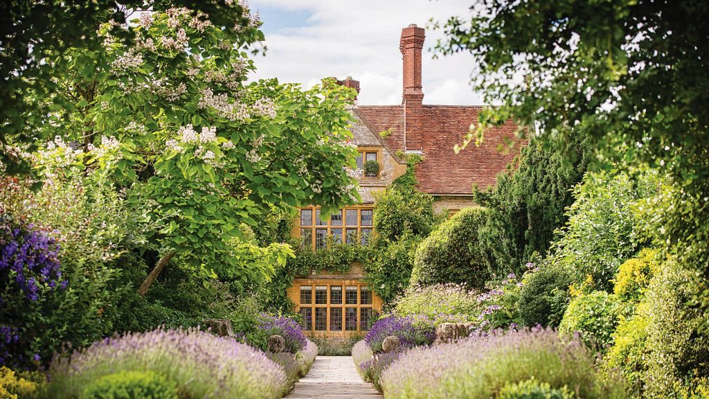 Belmond Le Manoir Aux Quat’Saisons peeking behind lush gardens