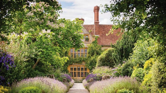 Belmond Le Manoir Aux Quat’Saisons peeking behind lush gardens