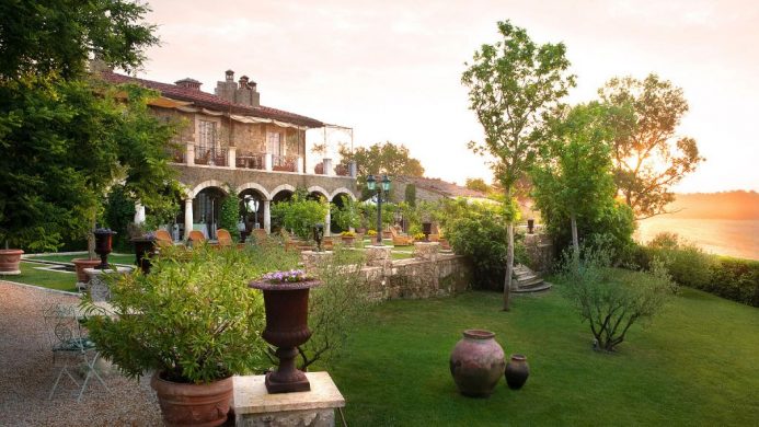 Sunset lawn with potted plants in front of Borgo Santo Pietro