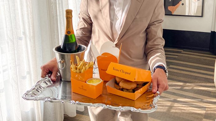 Champagne, burger and fries delivered on a silver platter at the Kimpton La Peer Hotel