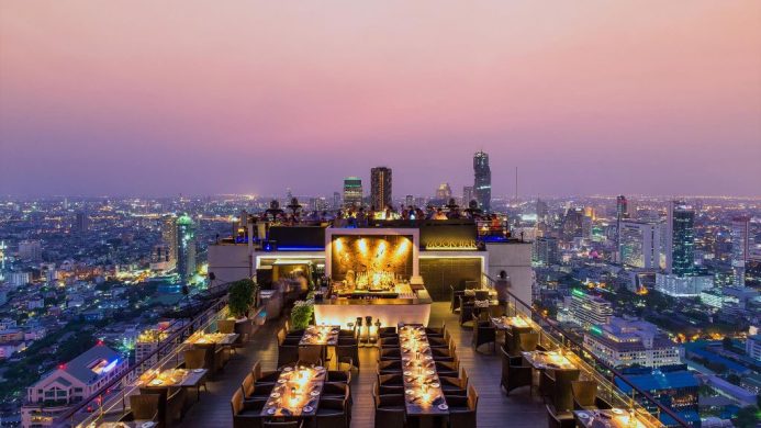 Banyan Tree Bangkok's rooftop Moon Bar towering over the city at dusk