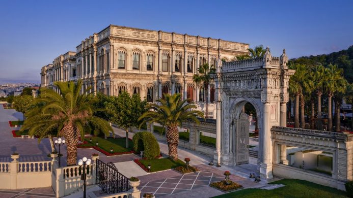 Exterior of Ciragan Palace Kempinski Istanbul with palm trees