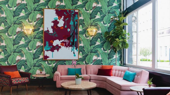 The Dwell Hotel's lounge a pink sofa and botanic wallpaper