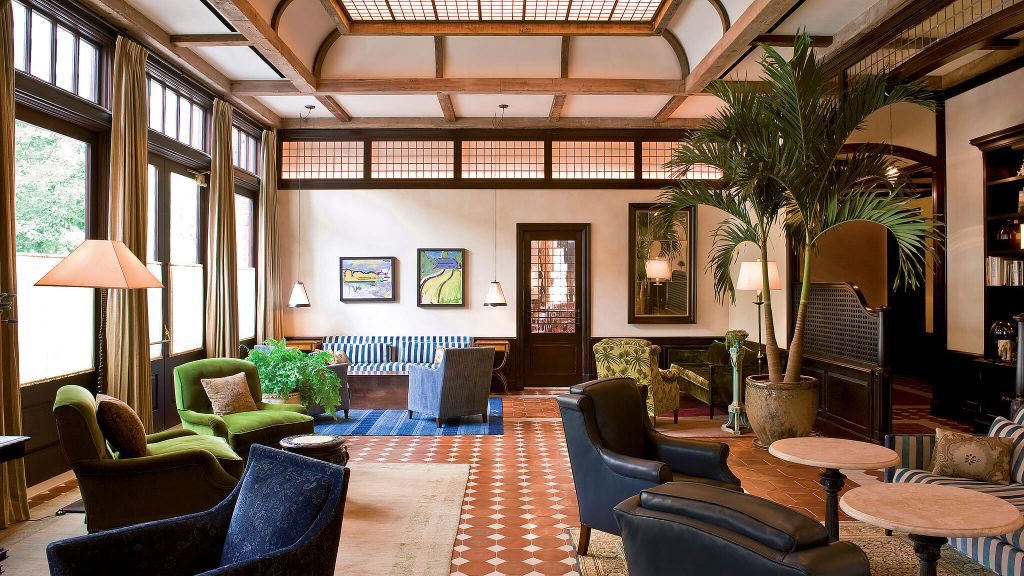 The Greenwich Hotel's lobby lounge with old style furniture and wooden wall and ceiling beams