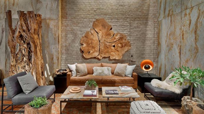 1 Hotel Central Park's lobby decorated with a brown leather couch, live-edge woods and potted plants