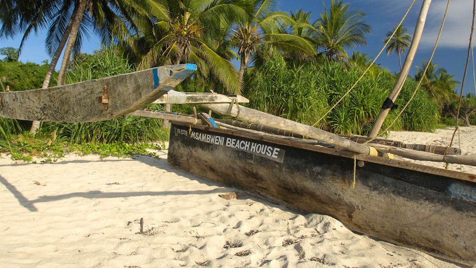 Msambweni Beach House-branded wooden boat stranded on the beach