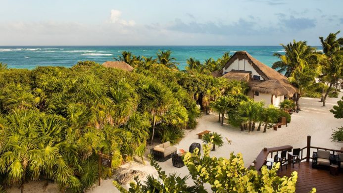 Mukan Resort on a white sand beach surrounded by many trees