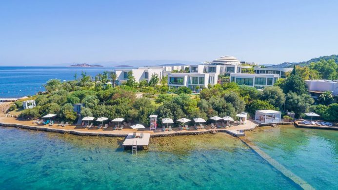 Susona Bodrum's white buildings on a peninsula by the sea