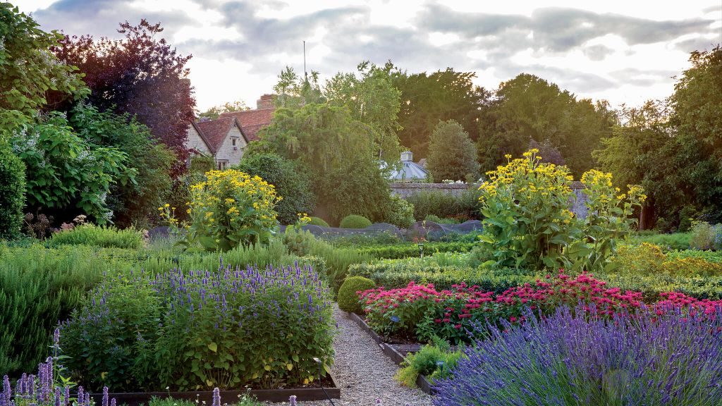 Le Manoir aux Quat'Saisons peeking out from behind a lush garden