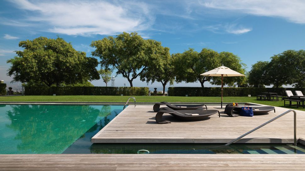 Hotel Miramar Barcelona's garden pool surrounded by trees