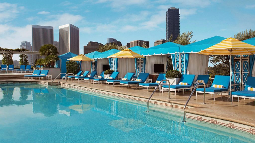 The Peninsula Beverly Hills' rooftop pool lined with cabanas