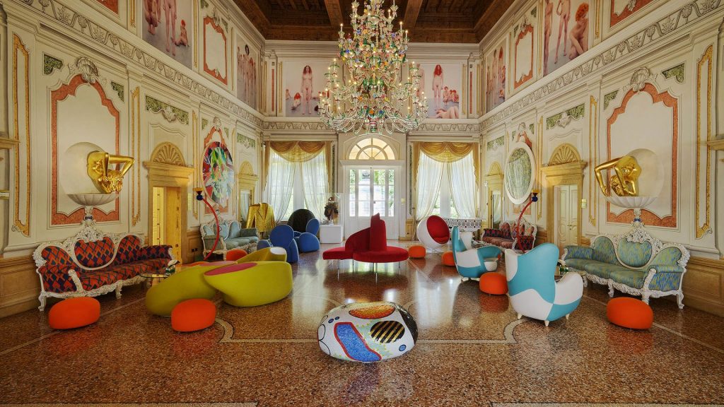Byblos Art Villa Amistà's Venetian-style lounge with a hanging chandelier, colorful modern furniture and a painted ceiling