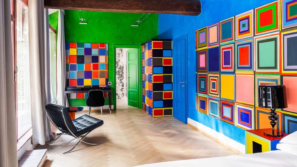 Galleria Vik Milano hotel's grand terrace galleria with colorful contemporary art on the walls