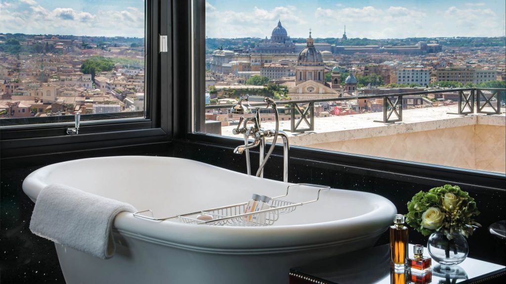 Soaking tub inside the Penthouse Suite of Hotel Hassler Roma, with an elevated view of the city of Rome