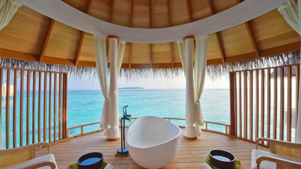 Freestanding bathtub in an open-air, overwater spa pavilion at Milaidhoo Island Maldives