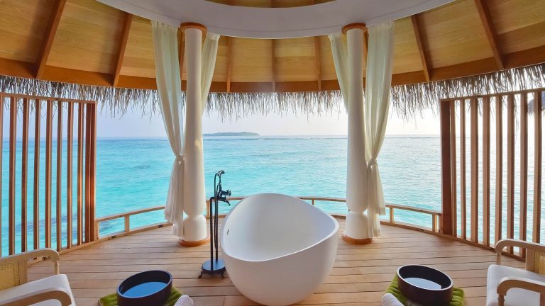 Freestanding bathtub in an open-air, overwater spa pavilion at Milaidhoo Island Maldives