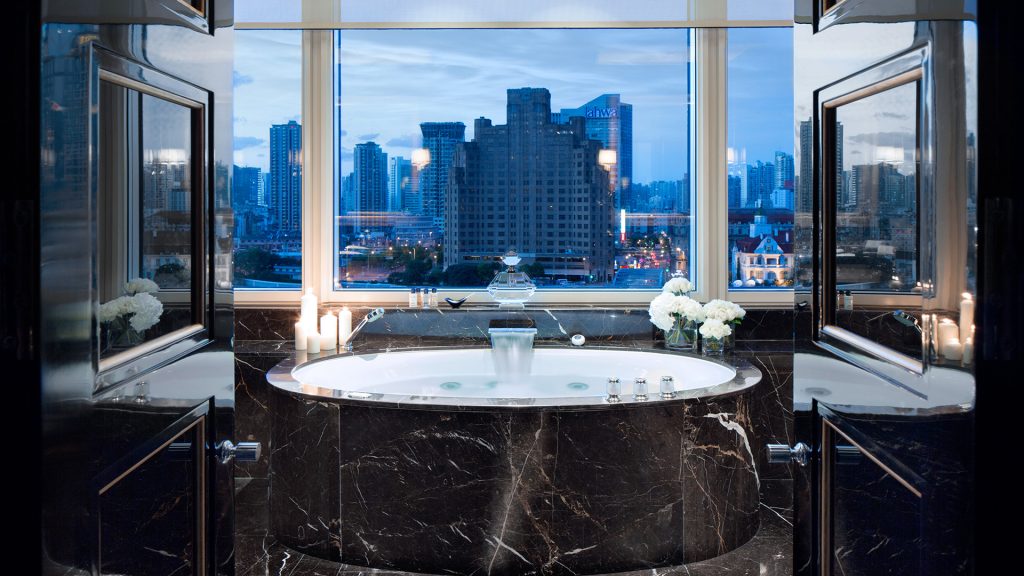 The Peninsula Shanghai's Majestic Suite marble bathroom with a view of the city