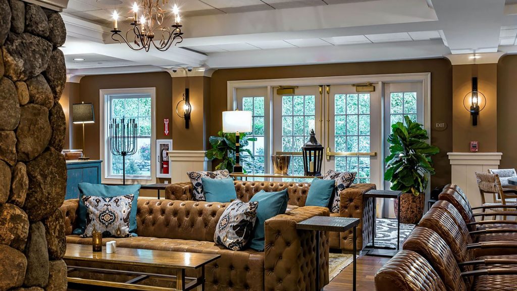 Bedford Village Inn's lobby lounge with comfy sofas and a stone fireplace