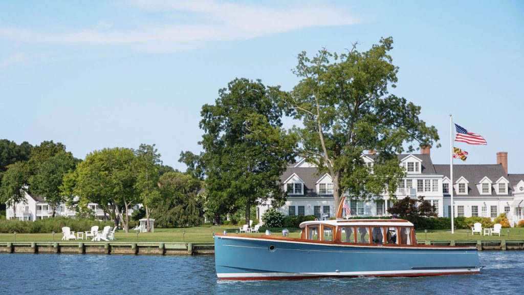 The Harbor Star boat drifting in front of the Inn at Perry Cabin
