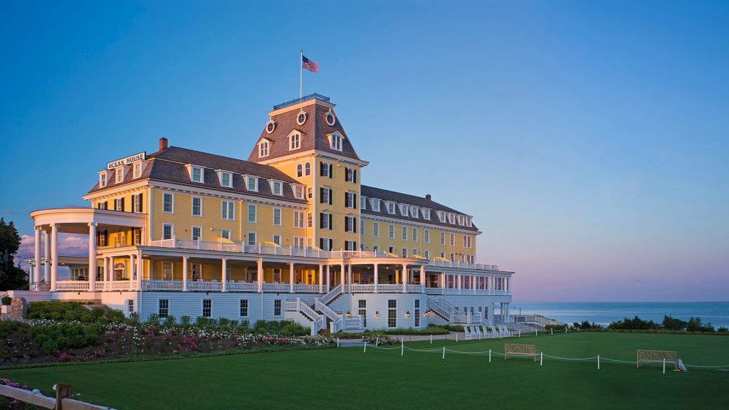 Exterior of Ocean House hotel by the water at golden hour