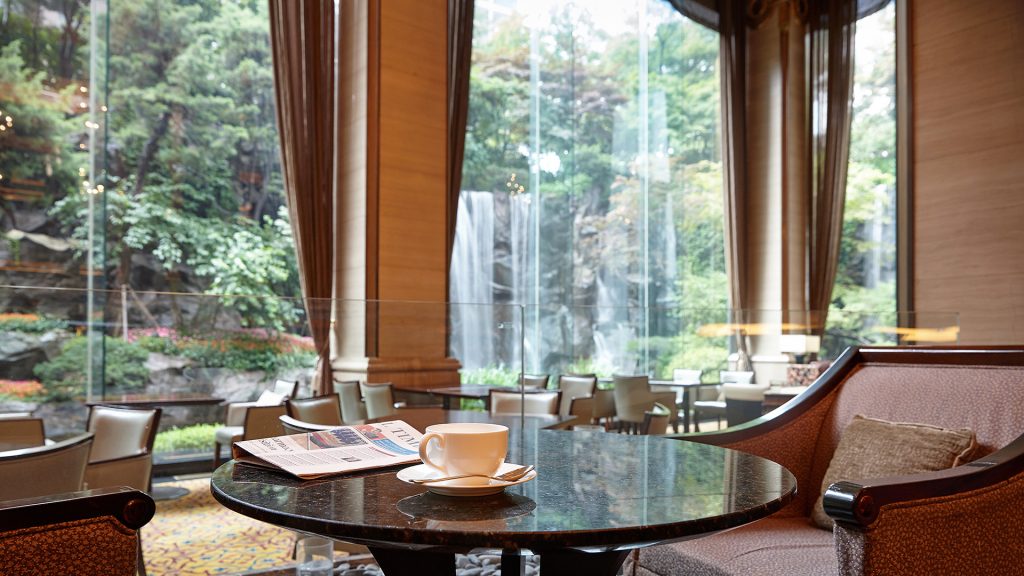 Lotte Hotel Seoul's Peninsula Lounge & Bar overlooking a garden with a waterfall