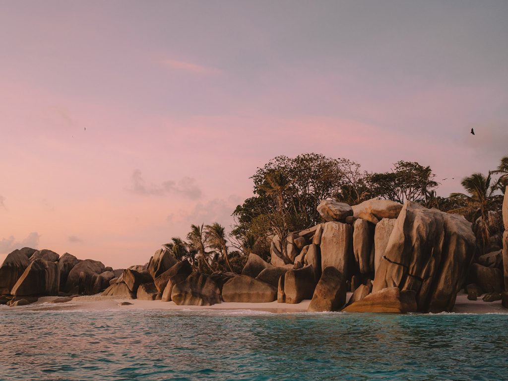 Sunset over iconic boulders at Six Senses Zil Pasyon