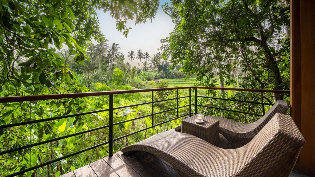luxury hotel amenities - Two chairs overlooking lush rice paddies at Kappa Senses Ubud, Bali.
