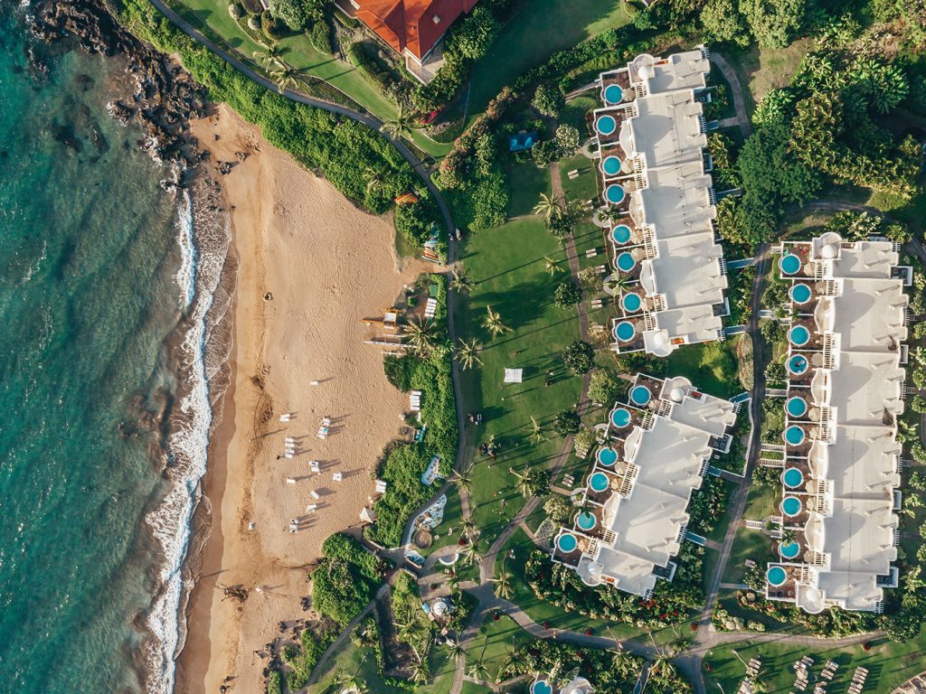 Aerial view of the beautiful beach at Fairmont Kea Lani, Maui, with golden sands and turquoise waters stretching along the coastline