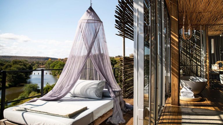 20 unforgettable stays - Singita Lebombo lodge suite with outdoor bed and canopy, overlooking a river