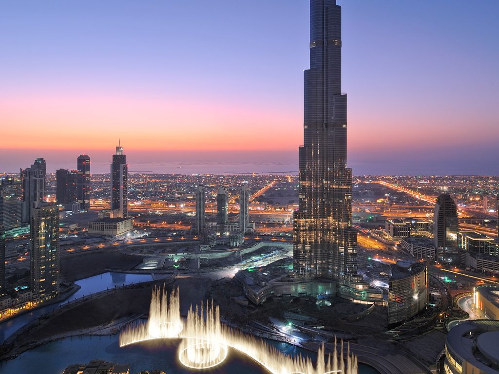 20 unforgettable stays - Dubai skyline viewed from a rooftop, in the evening