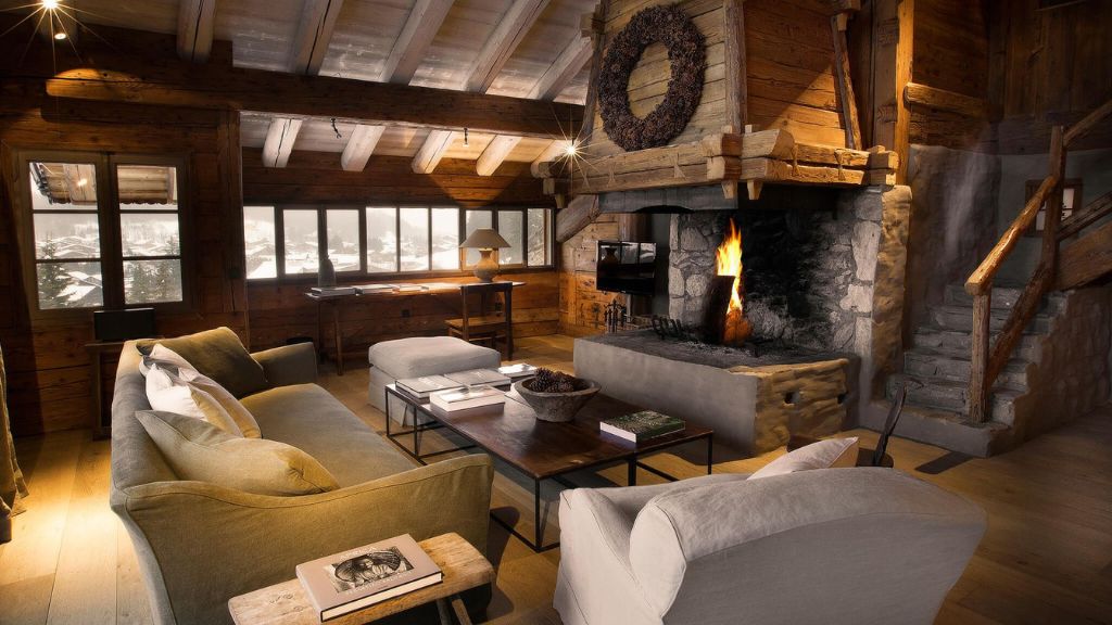coolest ski resorts - Zannier Hotels Le Chalet living room with a fireplace and couches