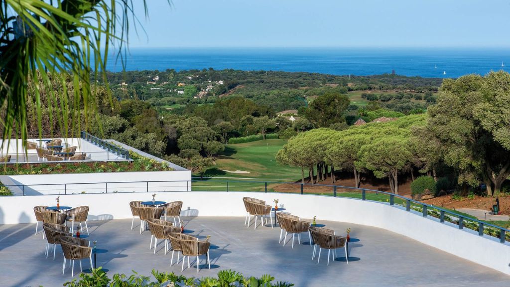 passion travel - SO/ Sotogrande - a white patio with chairs and tables on a white surface