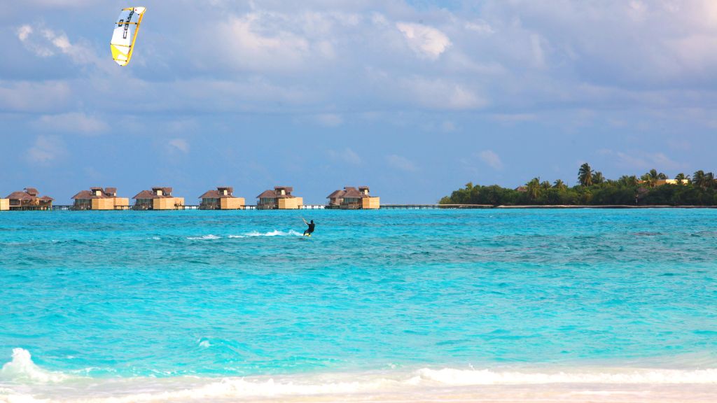 passion travel - Six Senses Laamu - a person kitesurfing in the ocean
