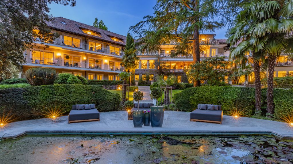 passion travel - Villa Eden - The Private Retreat - a large building with a pool and a large patio