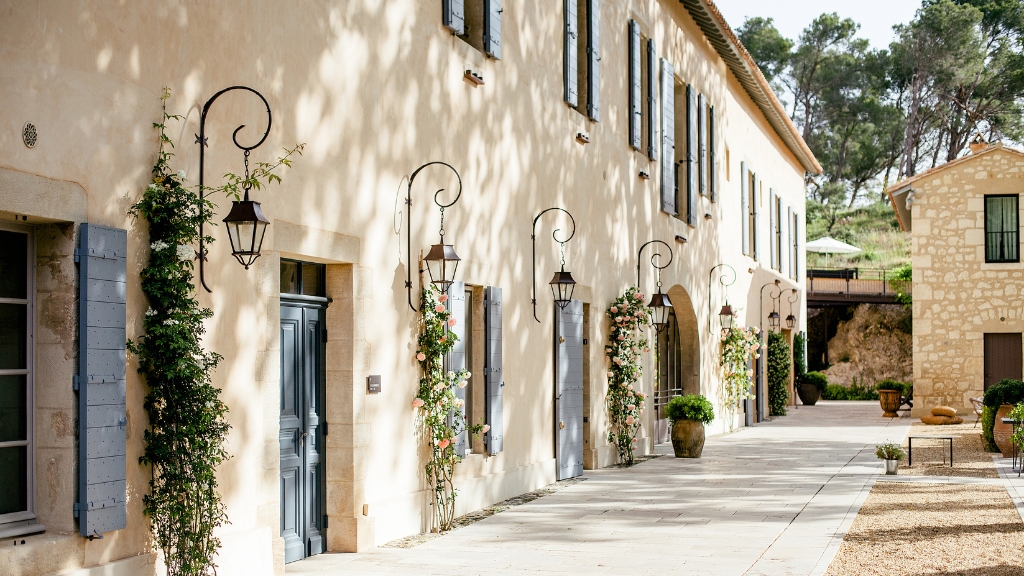 Best hotels in the South of France - Domaine de Manville - Les Baux-de-Provence - white stone facade with lanterns and greenery