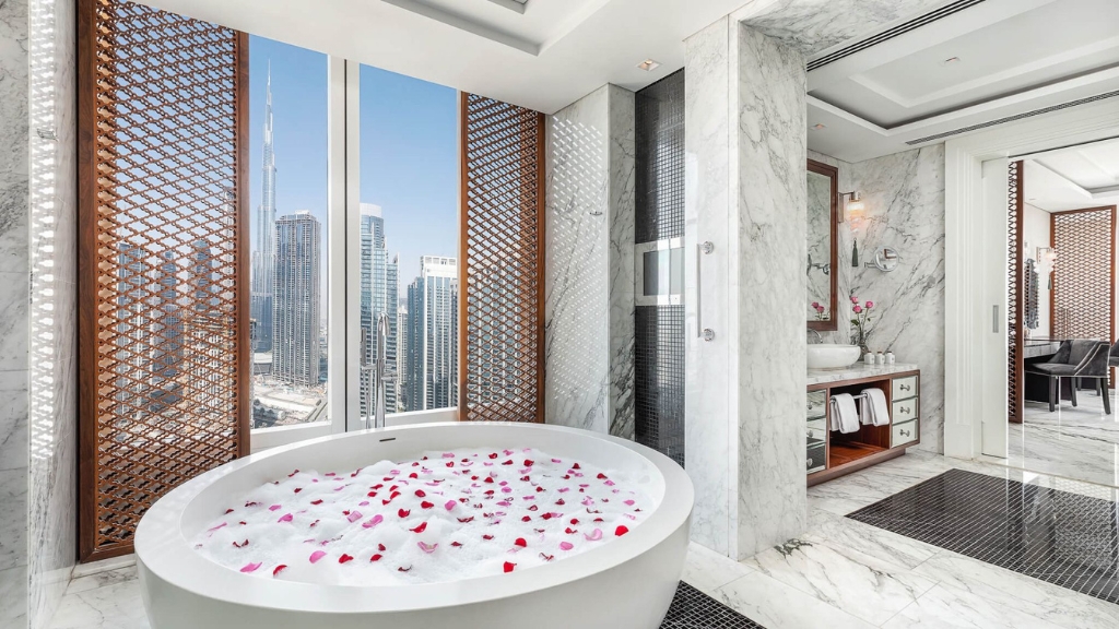 Proposal Hotels - Taj Dubai - Jet-Set Duo - a bathtub with rose petals in a bathroom
