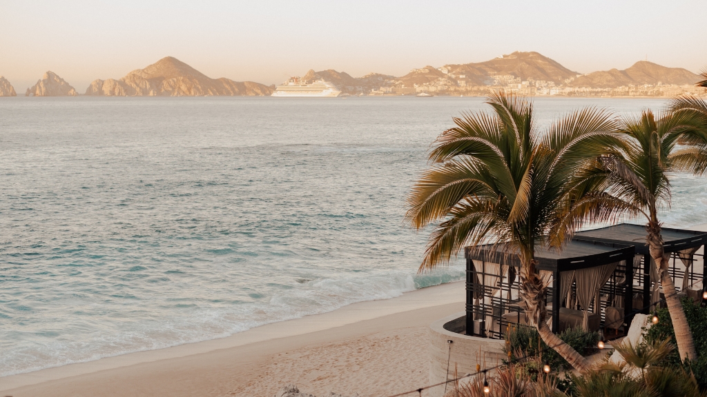 Proposal Hotels - The Cape, a Thompson Hotel - Stylish Adventurers - a beach with a building and palm trees
