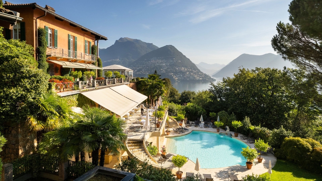 Proposal Hotels - Villa Principe Leopoldo Elegant Traditionalists - a pool with trees and mountains in the background