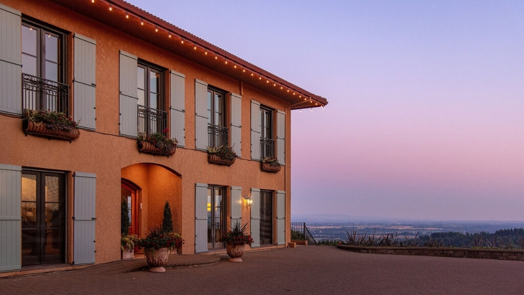 Small hotels | Black Walnut Inn & Vineyard, Dundee, Oregon, United States | a villa at sunset overlooking a vineyard