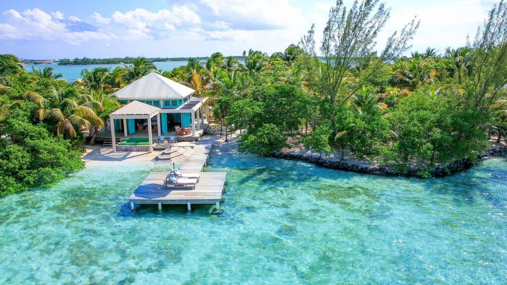 Small hotels | Cayo Espanto, San Pedro, Belize | luxury waterfront accommodation with a dock with trees around it