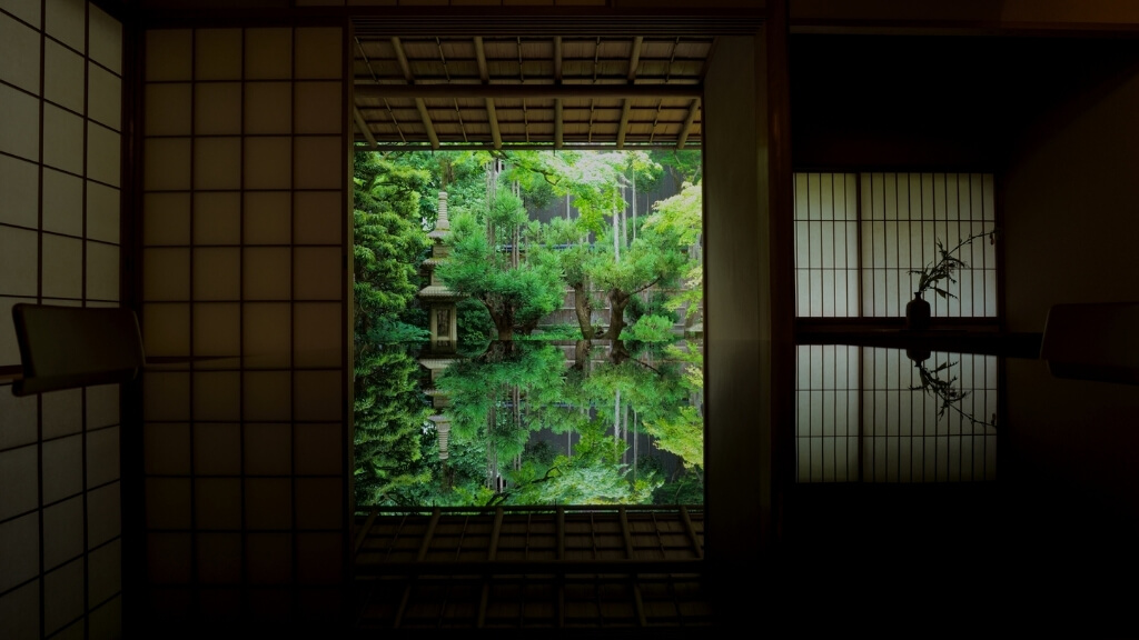 Small hotels | Shinsho-an, Kyoto, Japan | a view of a Japanese garden with a reflecting pool through a window