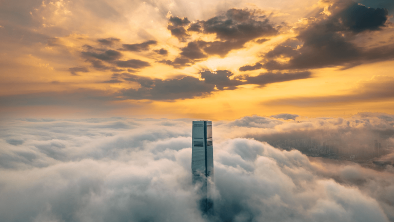 Skyscraper hotels - The Ritz-Carlton - Hong Kong - hotel breaking through the clouds at sunset
