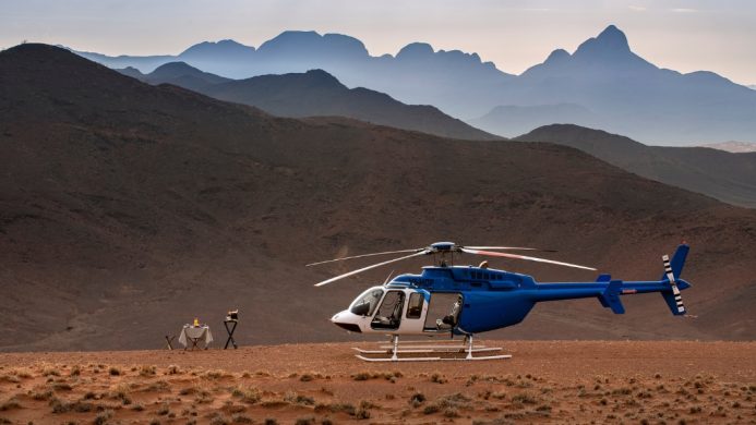 Picnic spots - &Beyond-Sossusvlei Desert Lodge - Sossusvlei, Namibia - blue helicopter with a picnic table to the left