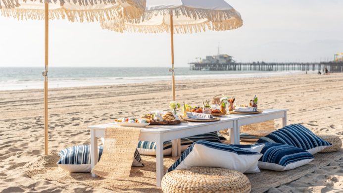 Picnic spots - Hotel Casa del Mar - Santa Monica, United States - picnic table, pillows and umbrellas set up on Santa Monica Beach