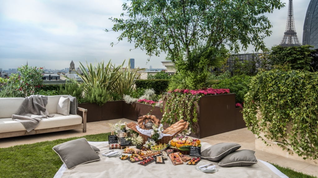 Picnic spots - The Peninsula Paris - Paris, France - food on a picnic blanket with the Eiffel Tower in the distance