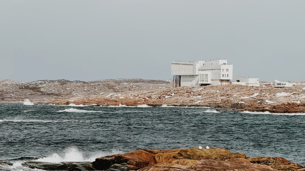 Educational vacations - Fogo Island Inn - Newfoundland, Canada - white exterior of the hotel behind the Atlantic