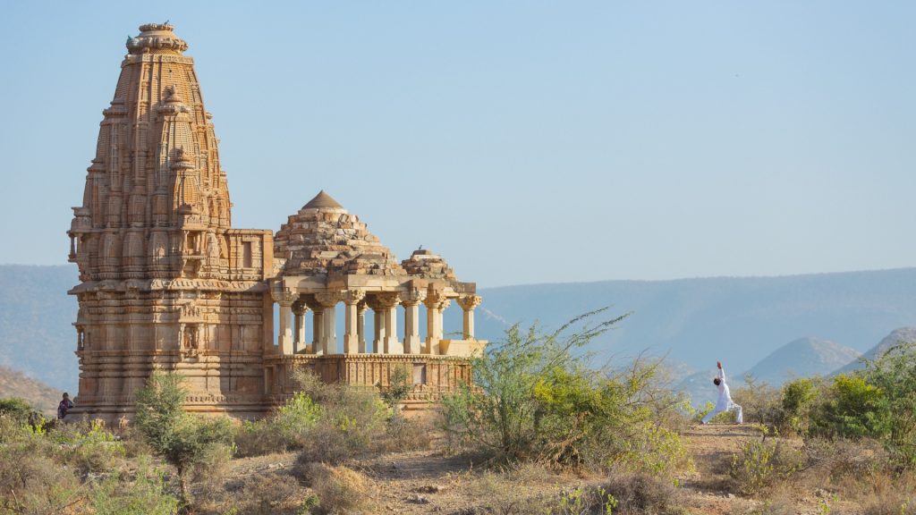 Educational vacations - Amanbagh - Ajabgarh, India - person doing yoga next to a temple