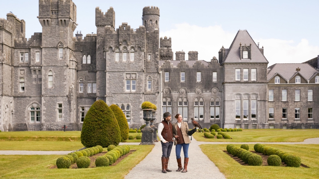 Educational vacations - The Lodge at Ashford Castle - Cong, Ireland - two people standing outside the hotel holding a hawk