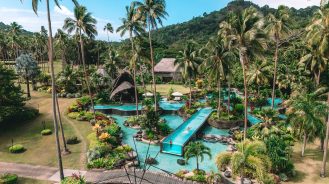 COMO Laucala Island Travel Diary by Jyo Shankar | people swimming in incredible poolscape
